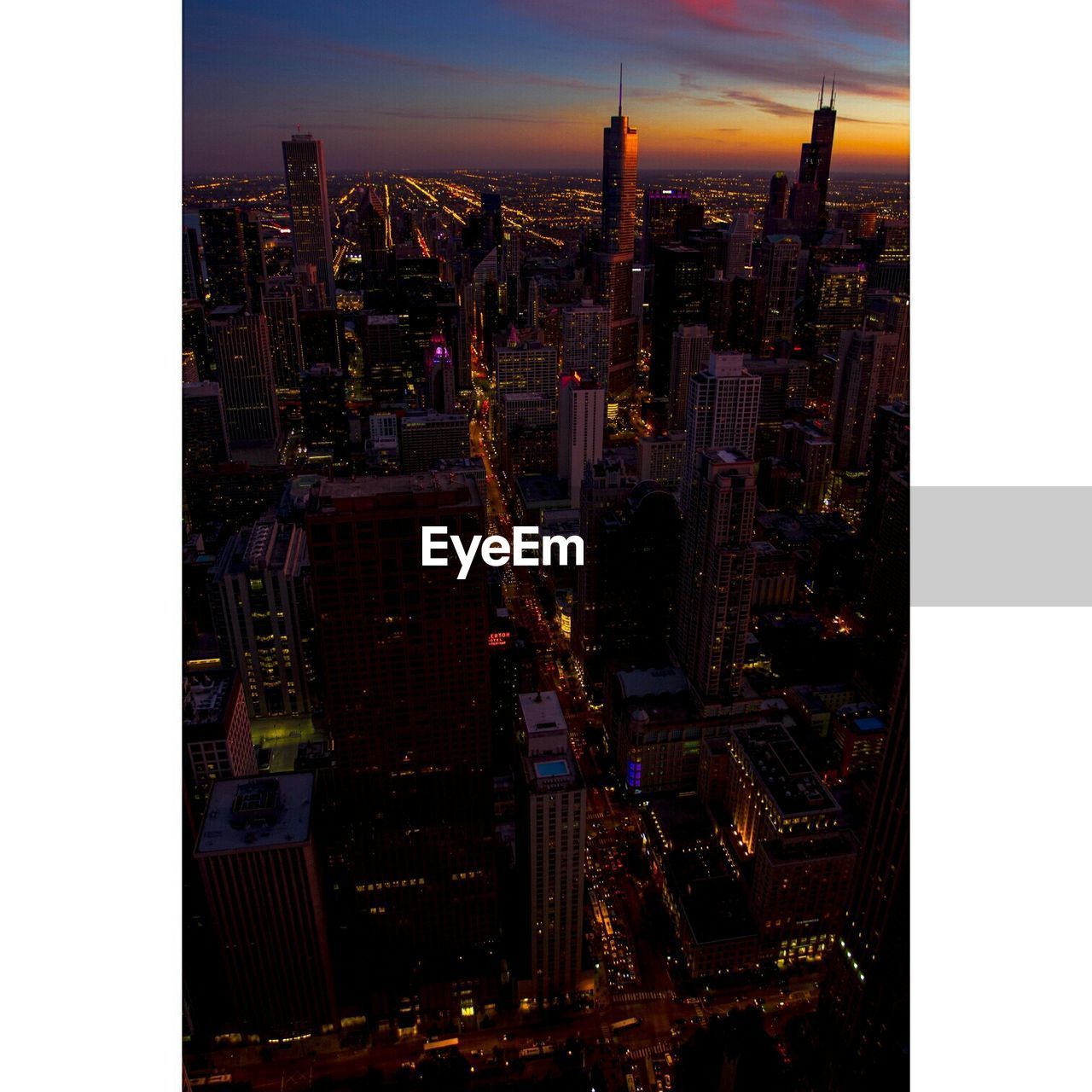 High angle view of illuminated cityscape during sunset