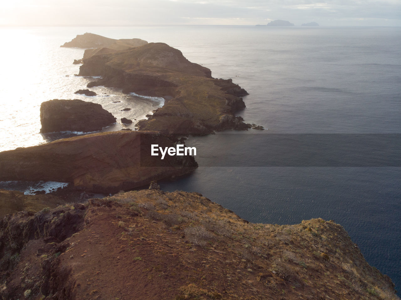 HIGH ANGLE VIEW OF ROCKS AT SEA SHORE