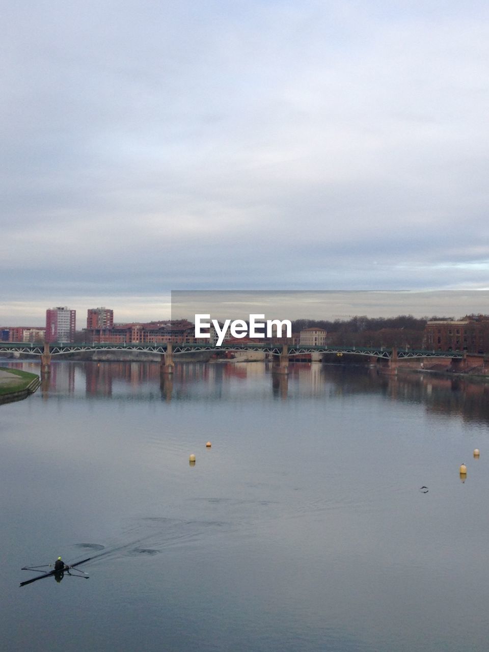 Scenic view of river and cityscape against sky