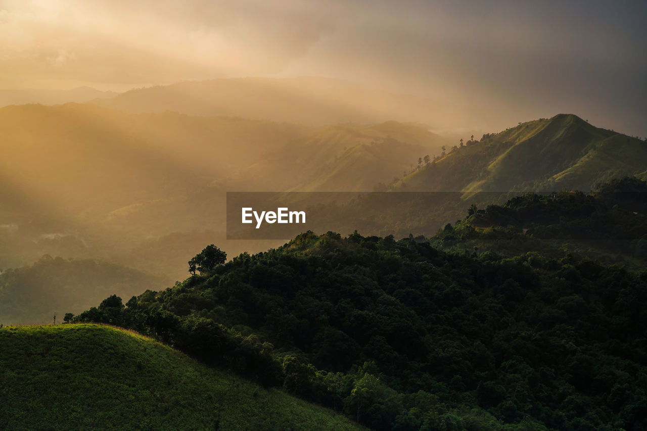 SCENIC VIEW OF MOUNTAIN AGAINST SKY DURING SUNSET