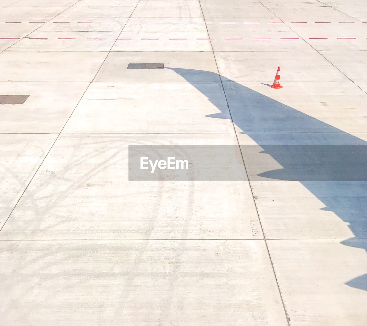 High angle view of aircraft wing shadow on runway