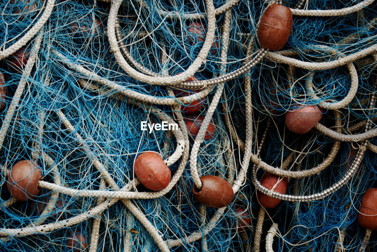 Close-up of blue colored fishing net - fishing net from a fisherman boat