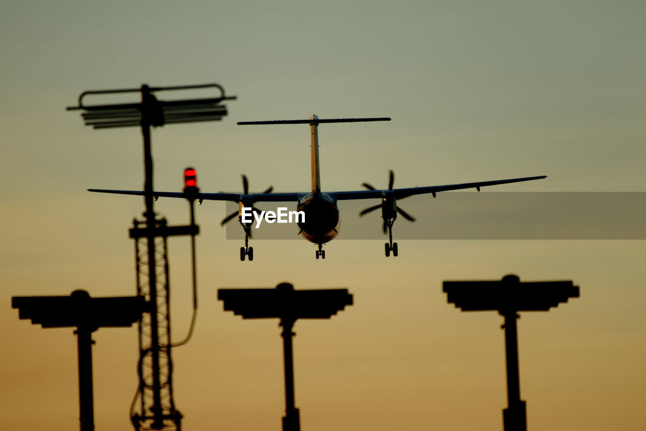 sky, silhouette, aircraft, no people, airplane, nature, aviation, sunset, transportation, air vehicle, vehicle, cross, outdoors