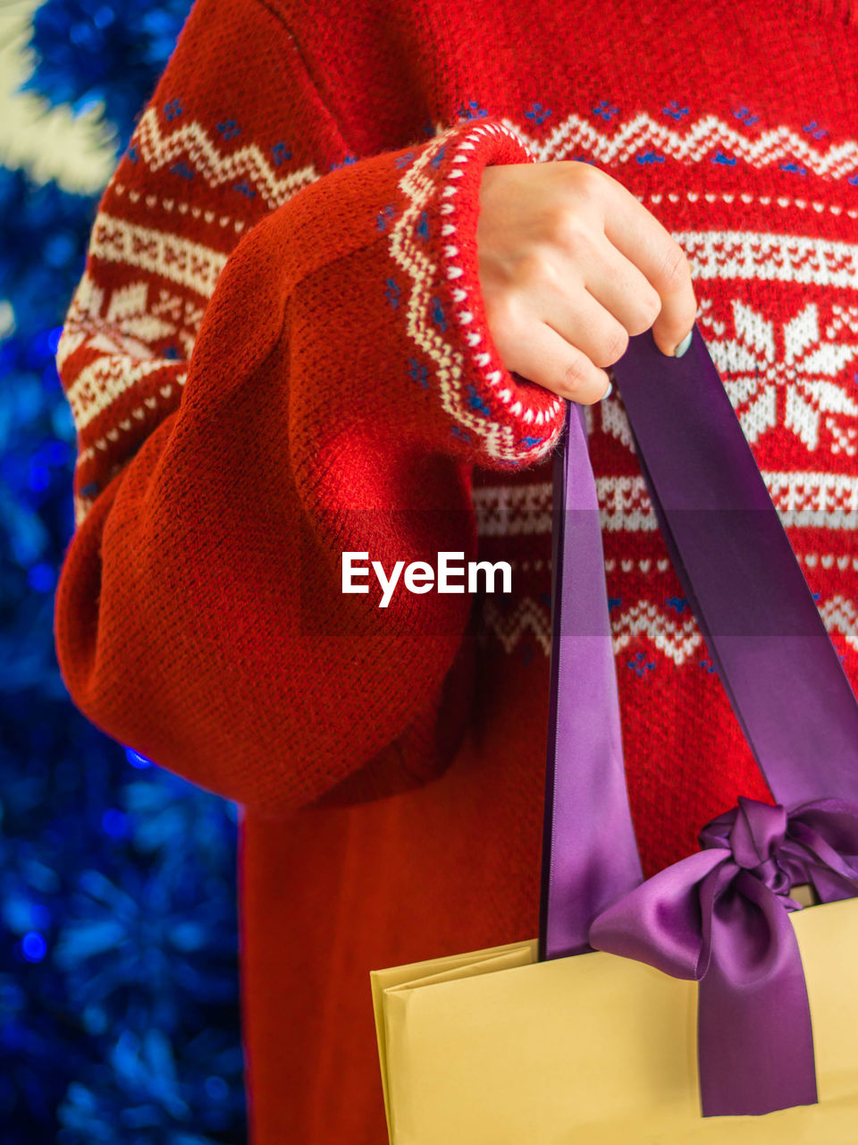 Midsection of woman holding bag during christmas