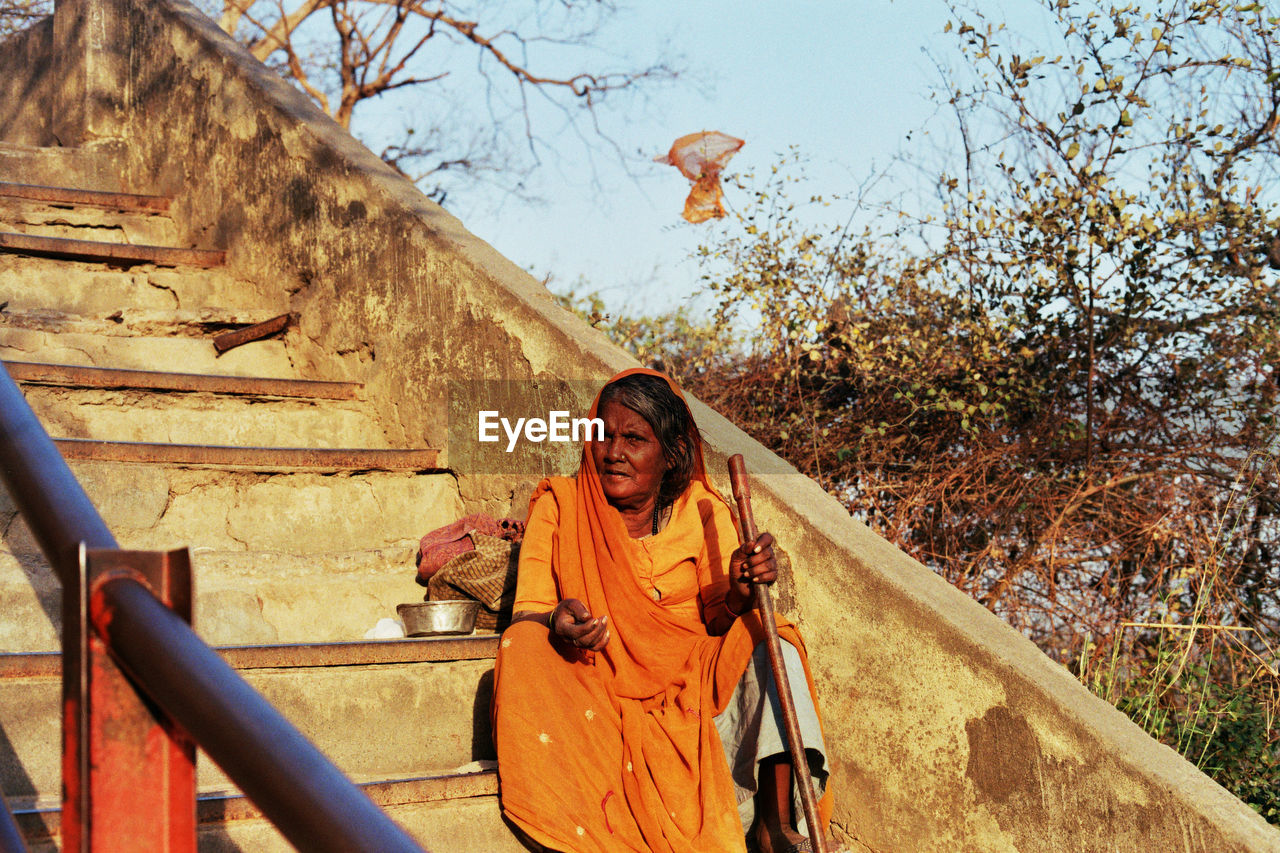 Beggar sitting on steps