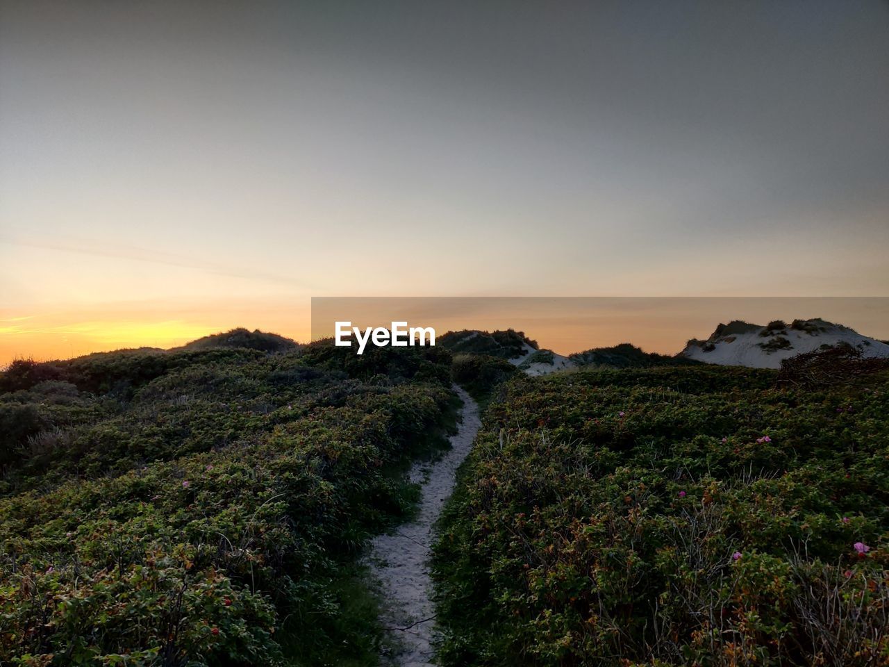 SCENIC VIEW OF LAND AGAINST SKY DURING SUNSET