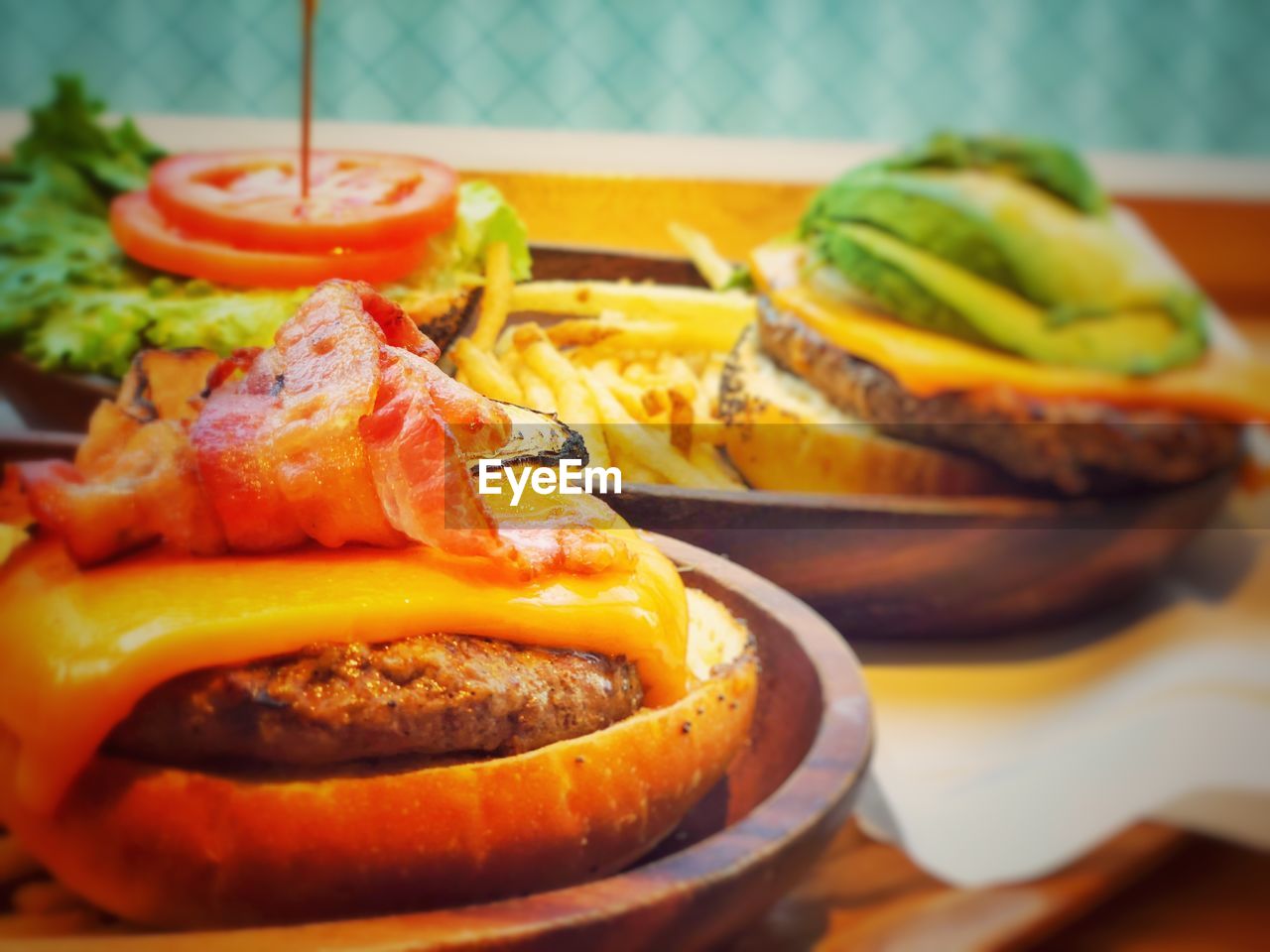 CLOSE-UP OF BURGER ON TABLE