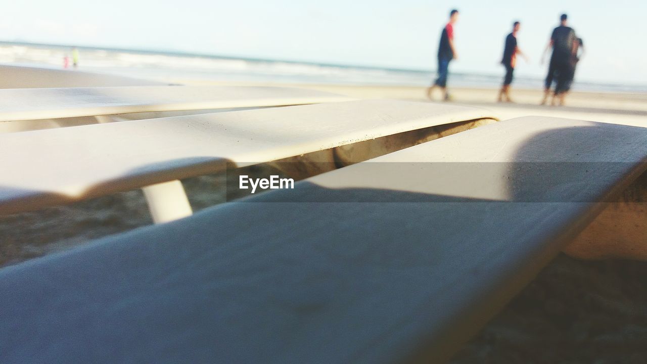 Close-up of lounge chair at beach