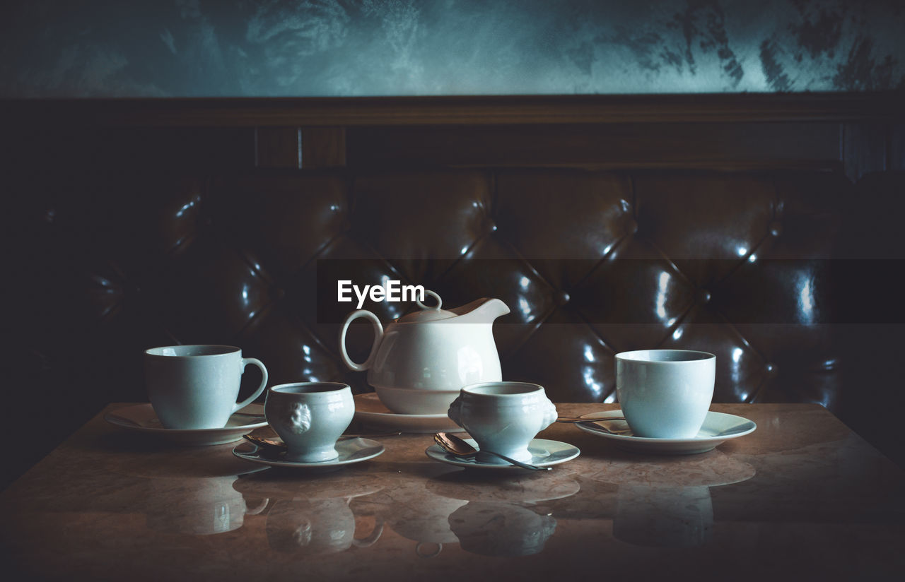 Close-up of coffee cups on table