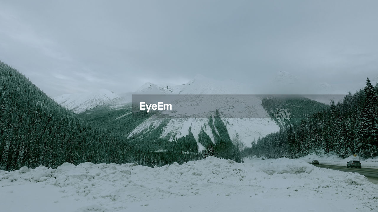 Snow covered landscape against sky