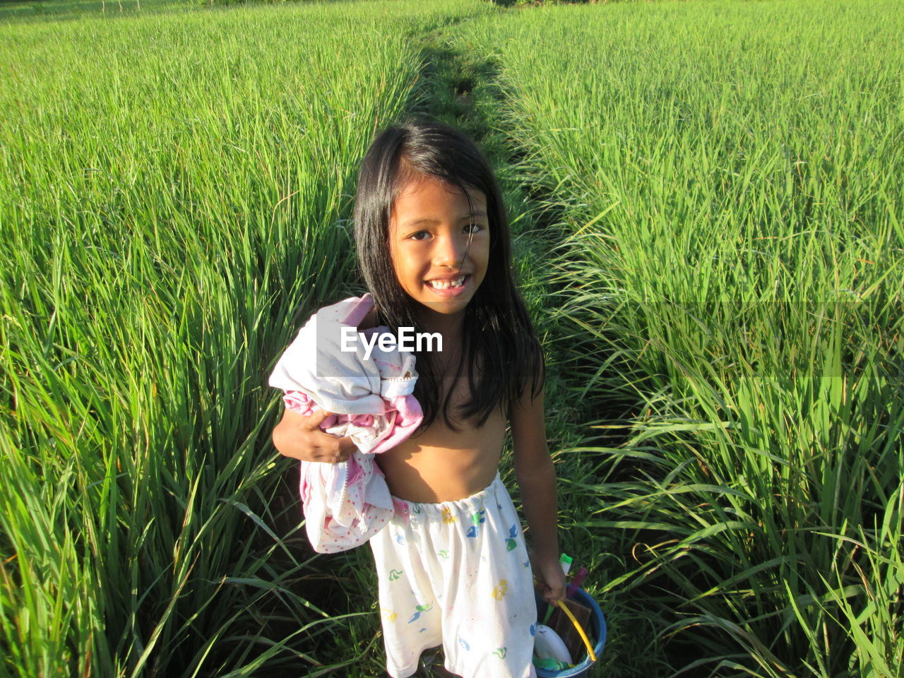 Portrait of girl standing in farm