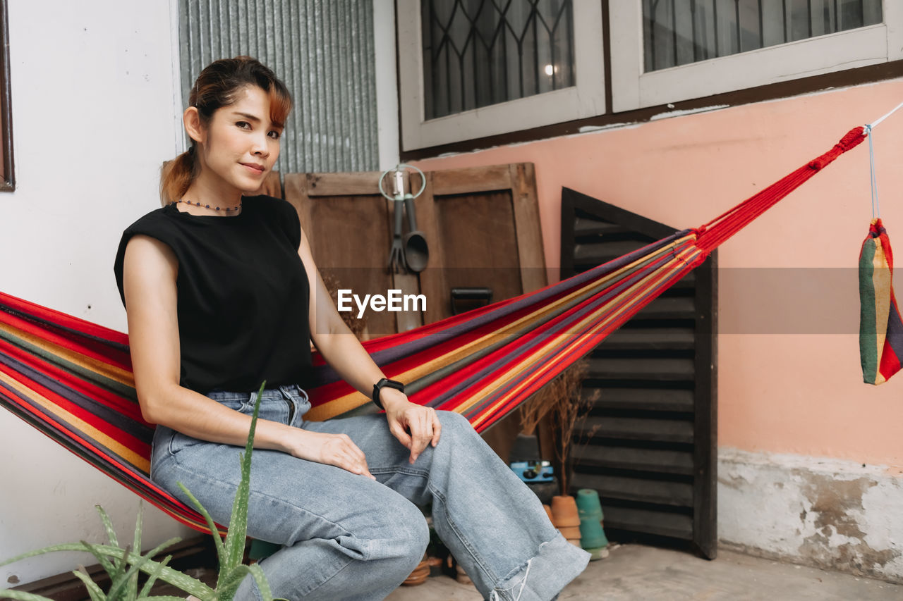 Smiling young woman sitting outdoors