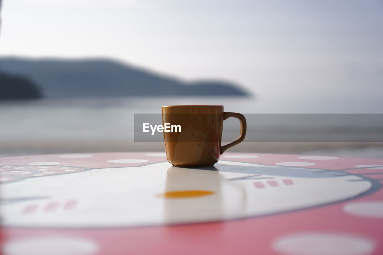 Close-up of coffee cup on table