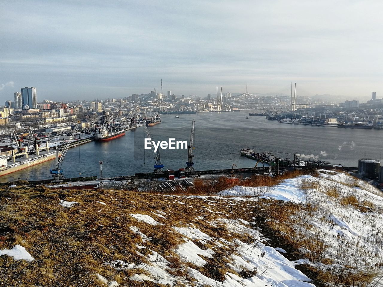 High angle view of bay amidst buildings in city during winter