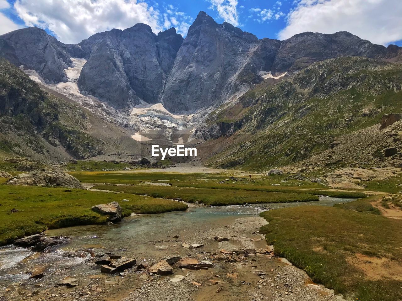 Scenic view of stream by mountains