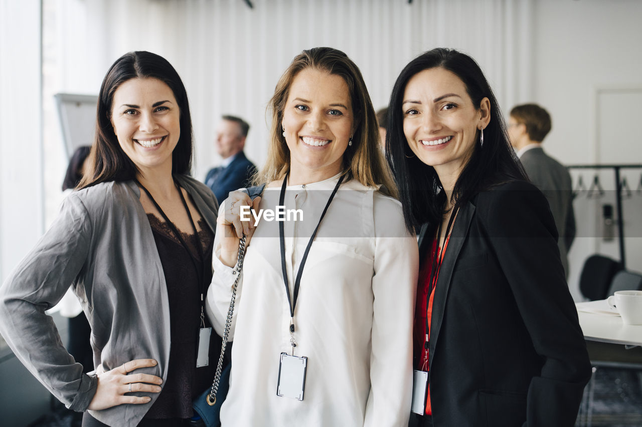 Portrait of female entrepreneurs standing at workplace