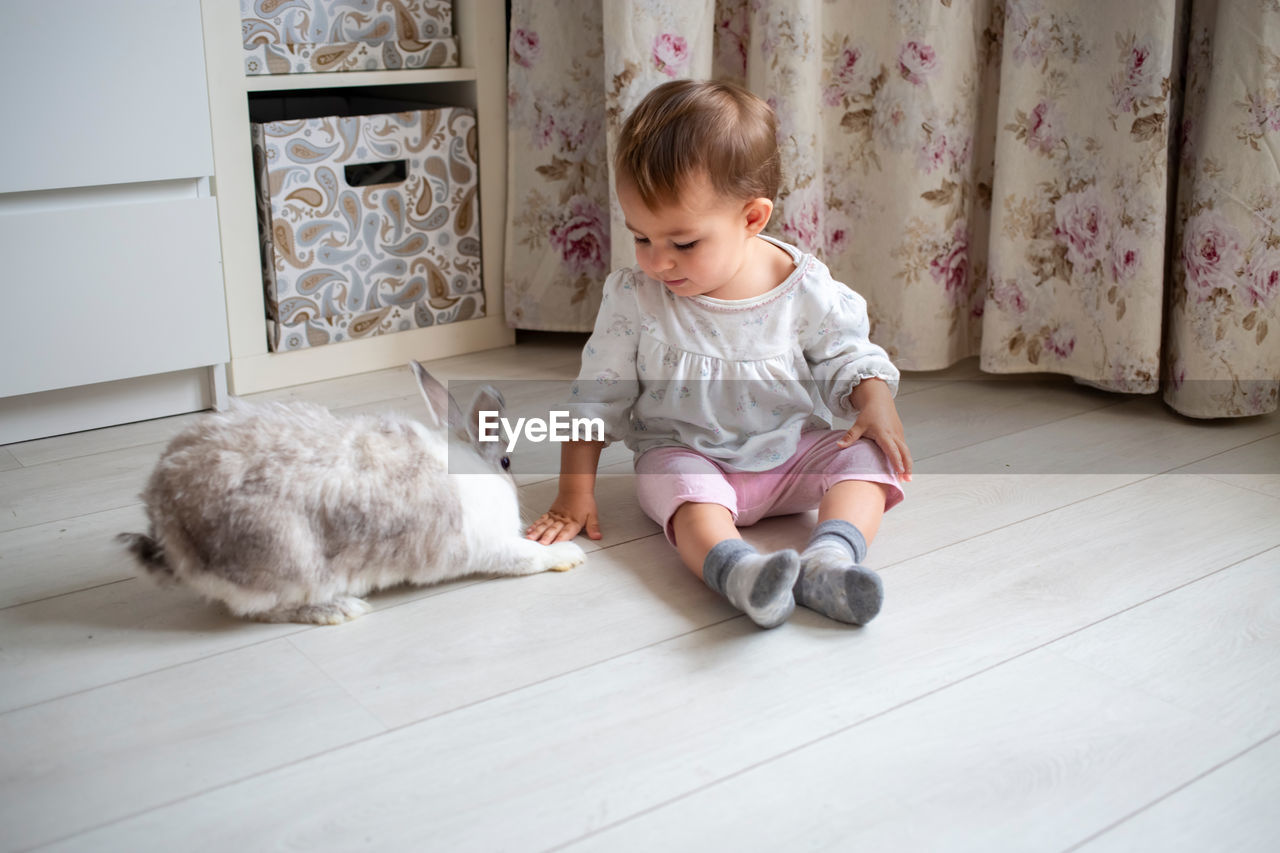 Cute baby girl lying on floor