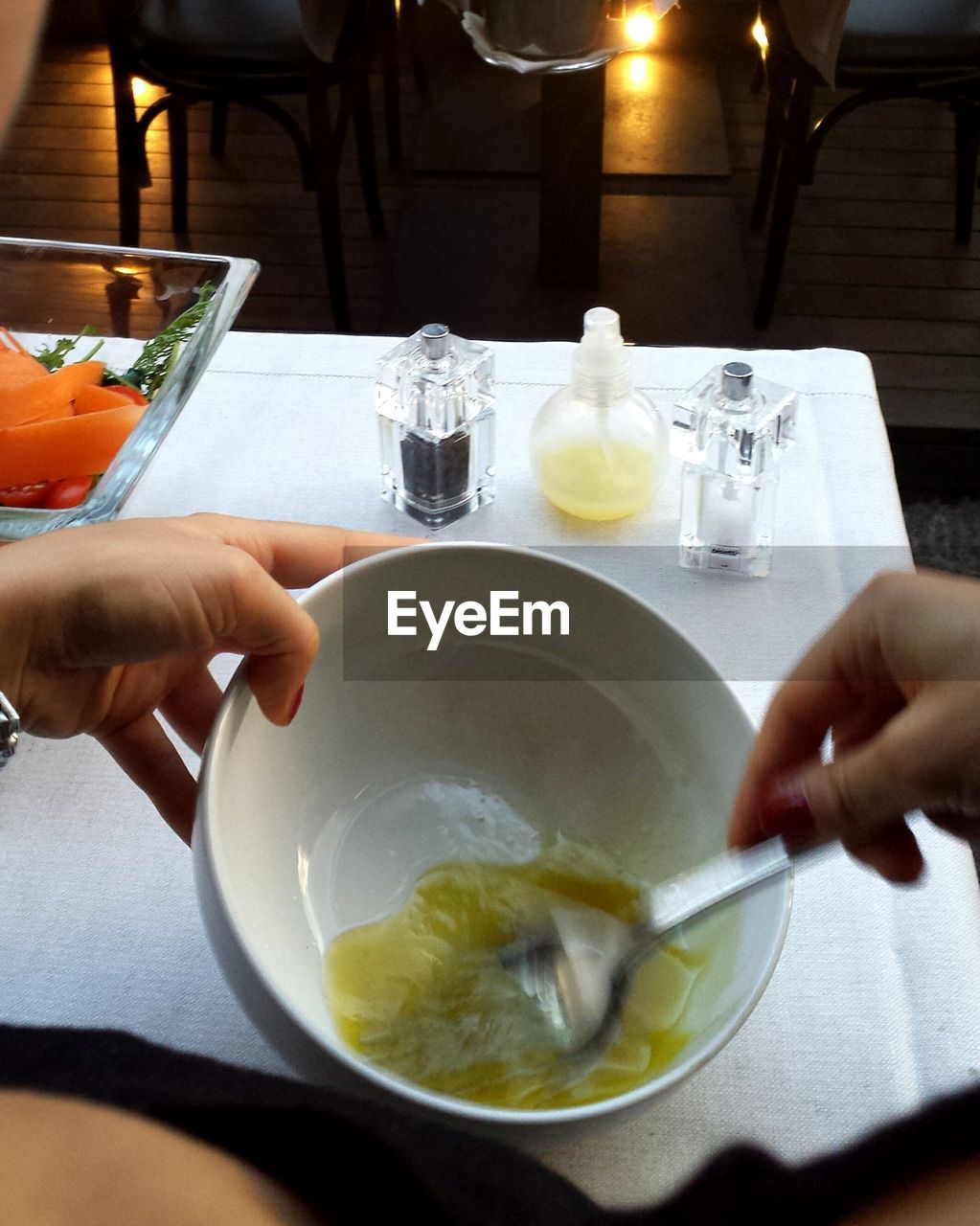 Cropped image of woman preparing salad