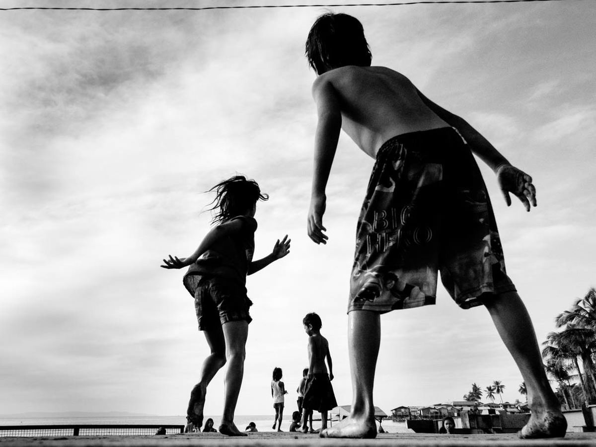 LOW ANGLE VIEW OF FRIENDS ON BEACH