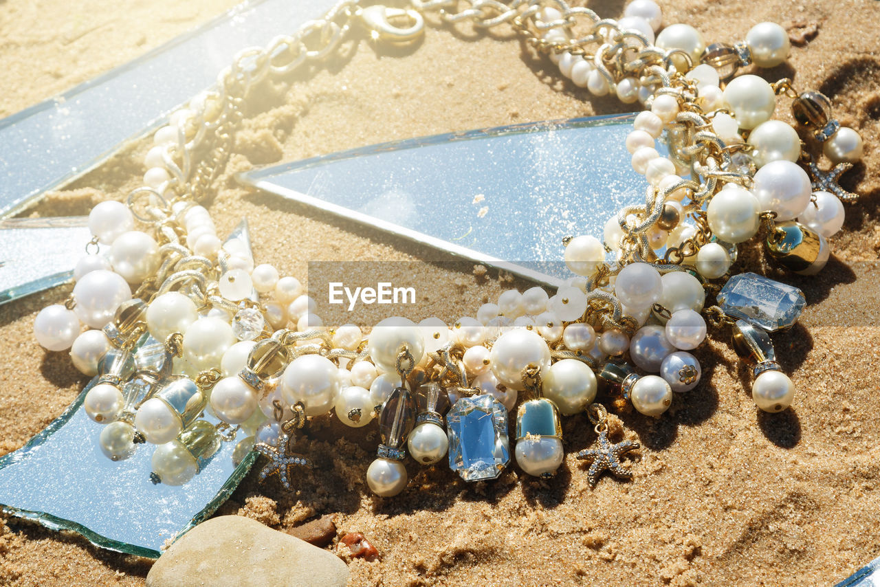 high angle view of wedding rings on beach