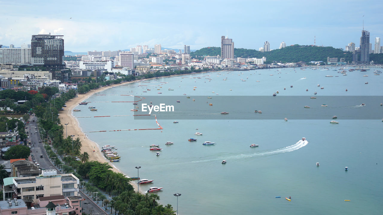 High angle view of buildings by sea against sky