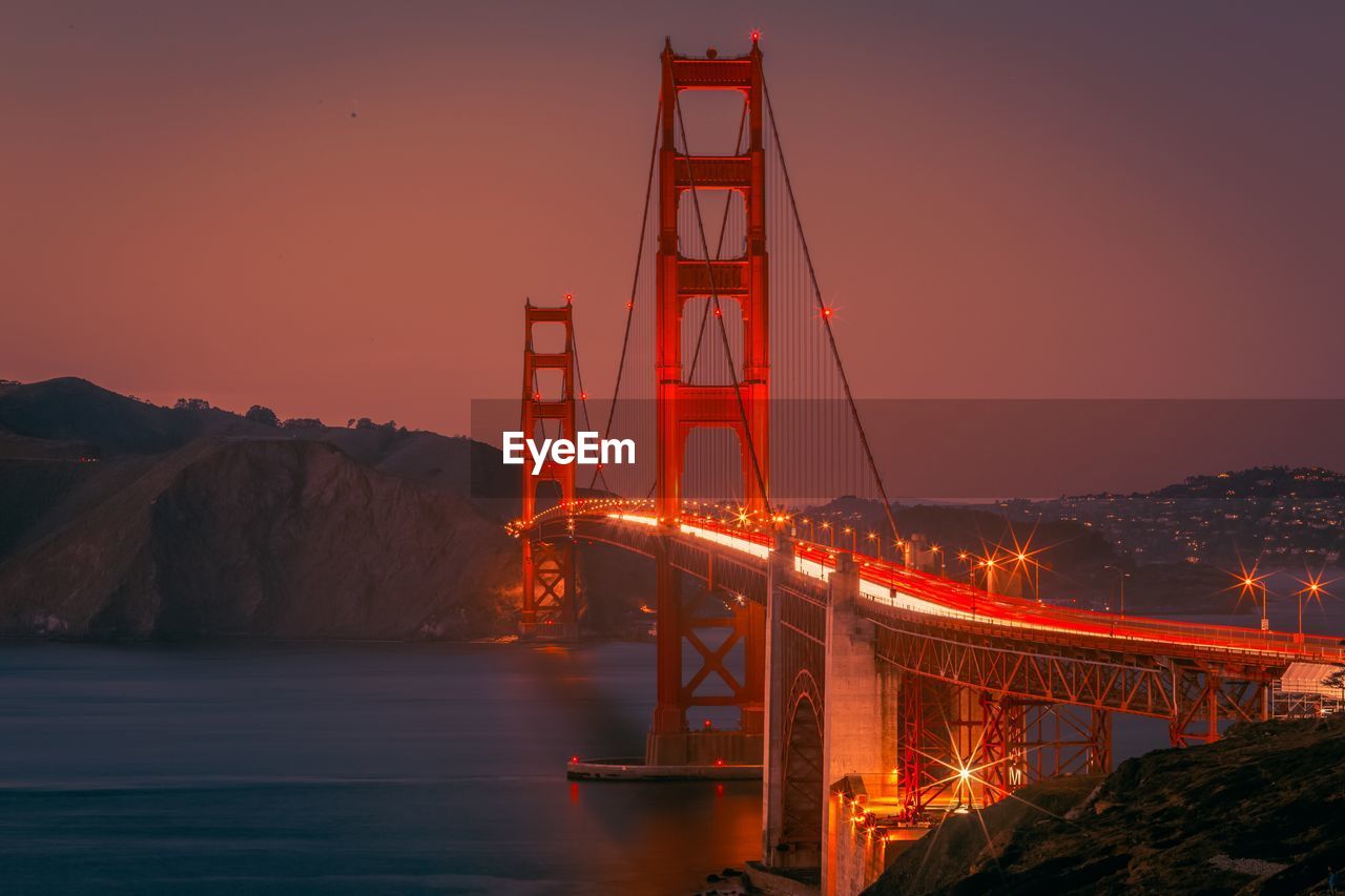 ILLUMINATED SUSPENSION BRIDGE AT NIGHT