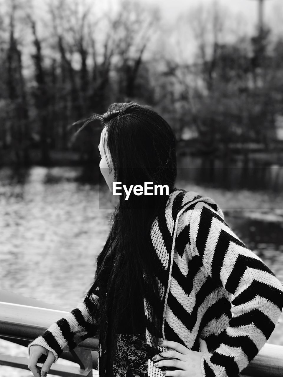 Close-up of woman looking away while standing outdoors