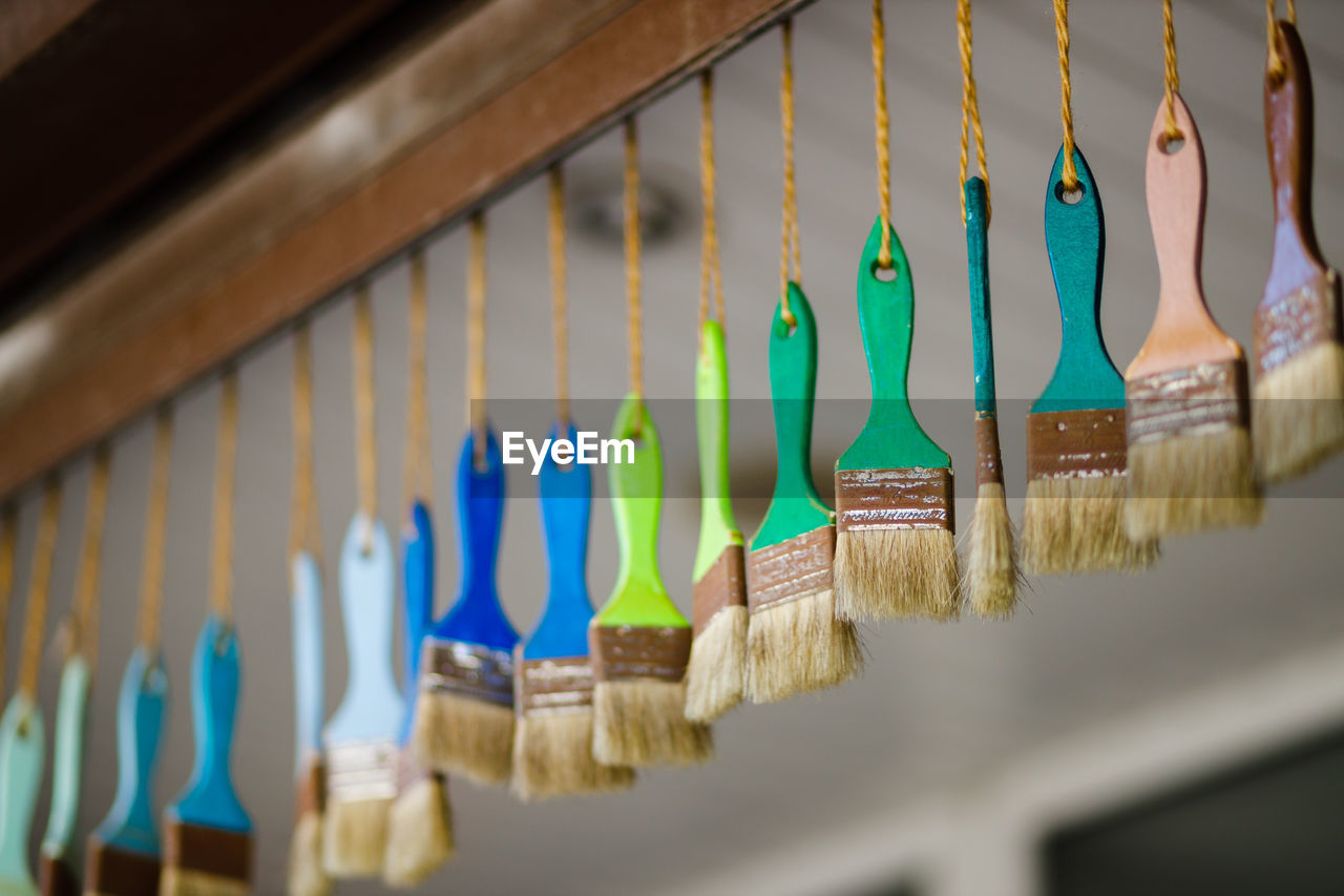 Close-up of multi colored paintbrush hanging for sale