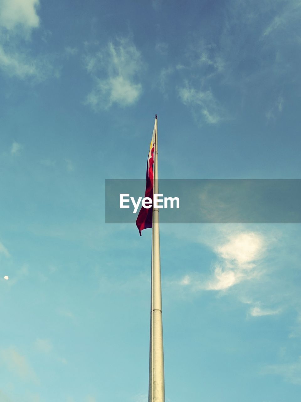 Low angle view of flag against sky