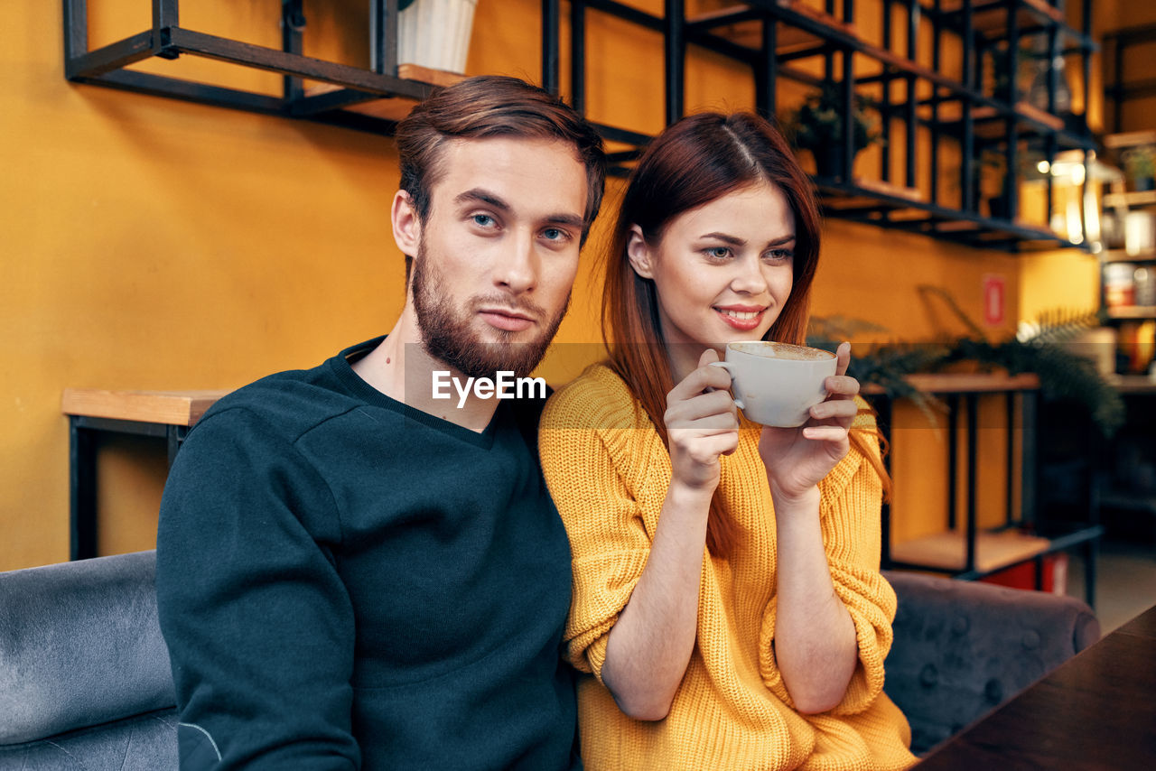 Young couple sitting at cafe