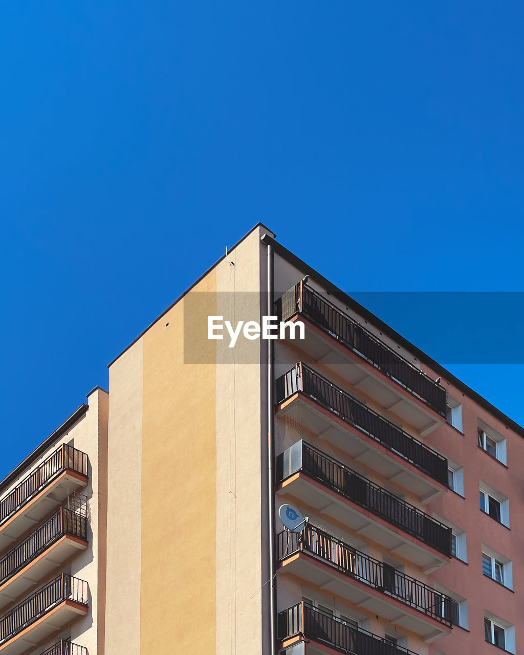 Low angle view of building against clear blue sky