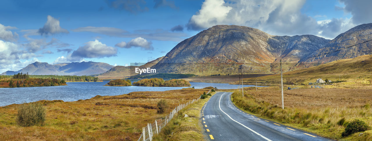 Panoramic view of road by mountains against sky