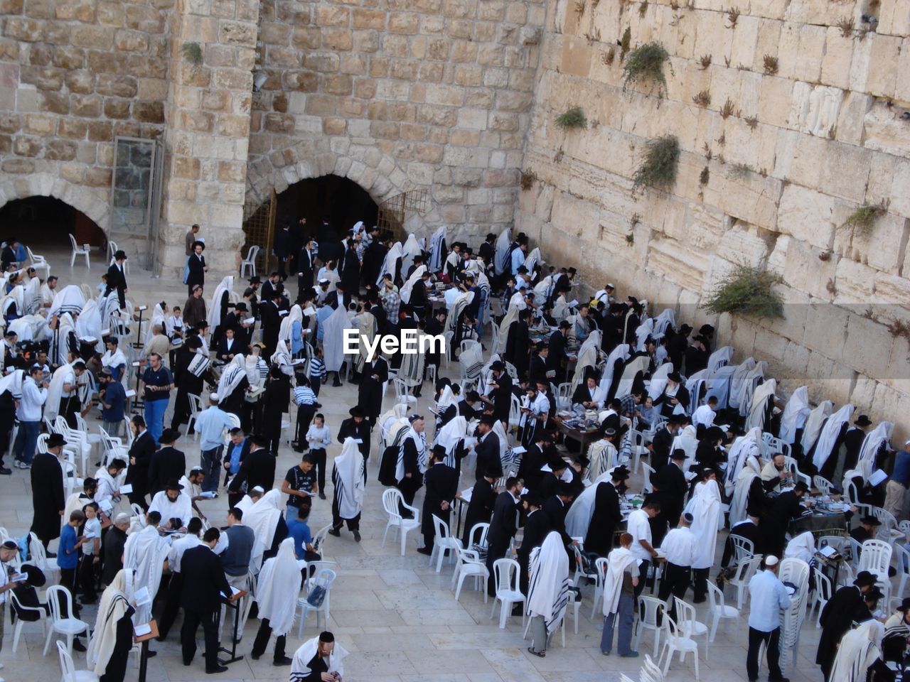 High angle view of people praying by western wall