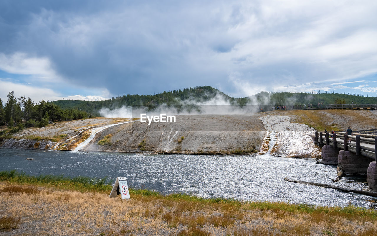 Scenic view of eruption by firehole river in midway geyser at yellowstone park