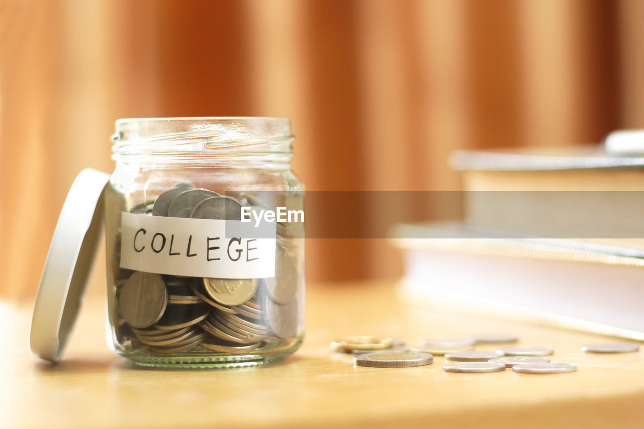 CLOSE-UP OF COINS IN JAR