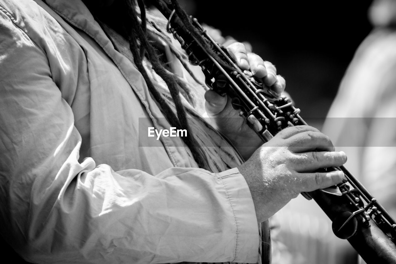 Close-up of man playing clarinet