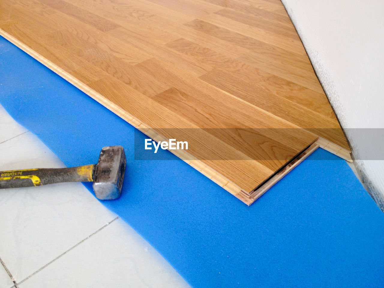 flooring, floor, indoors, tool, diy, high angle view, work tool, home improvement, home interior, wood, blue, improvement, no people, equipment, hand tool, construction industry, copy space, wing, industry