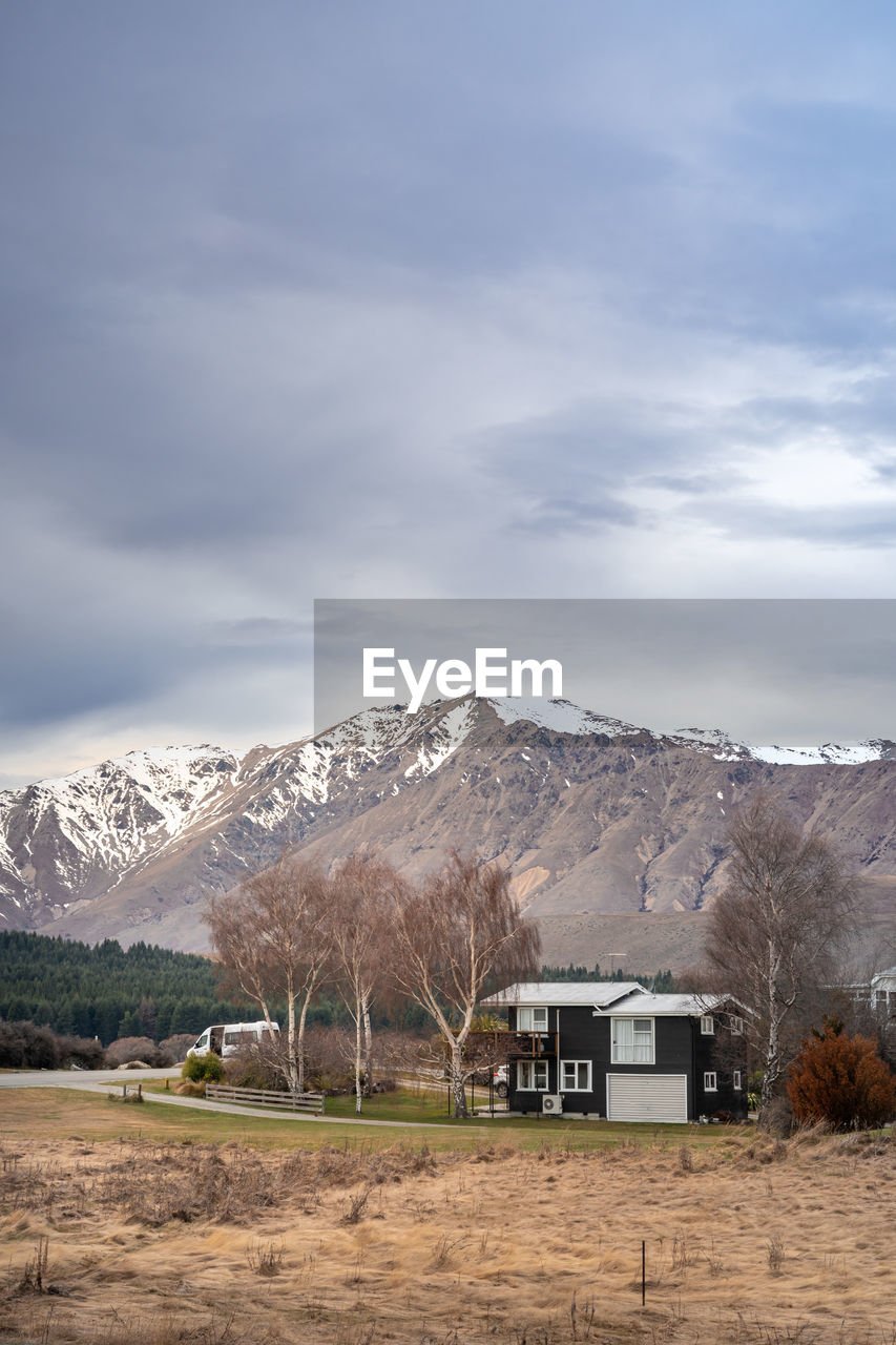 Sunrise view of the housing estate at lake tekapo in late winter with beautiful snow capped mountain