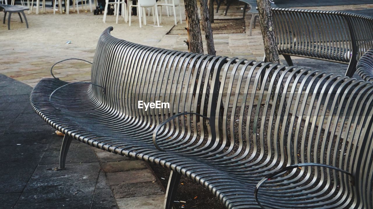 Empty metal bench on street