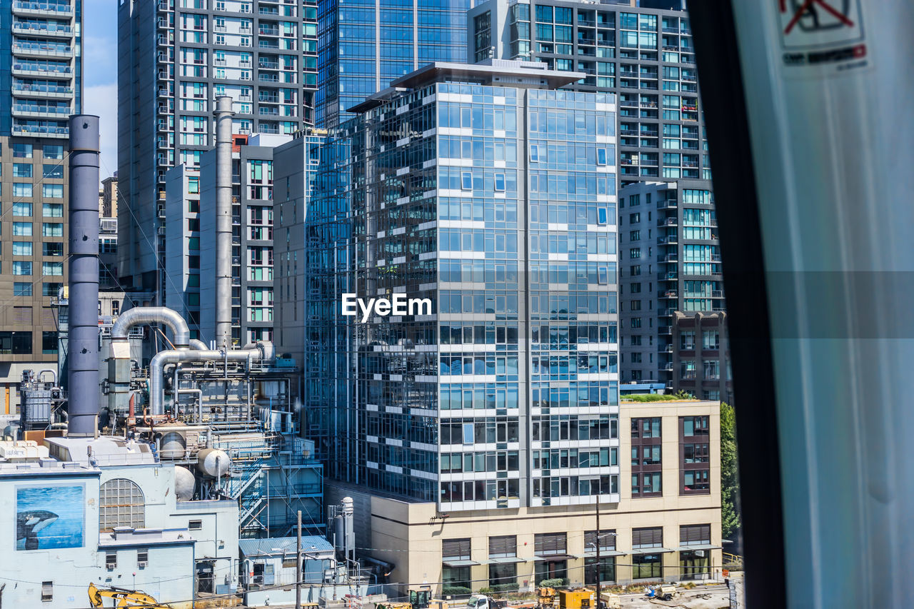 REFLECTION OF BUILDINGS IN GLASS WINDOW