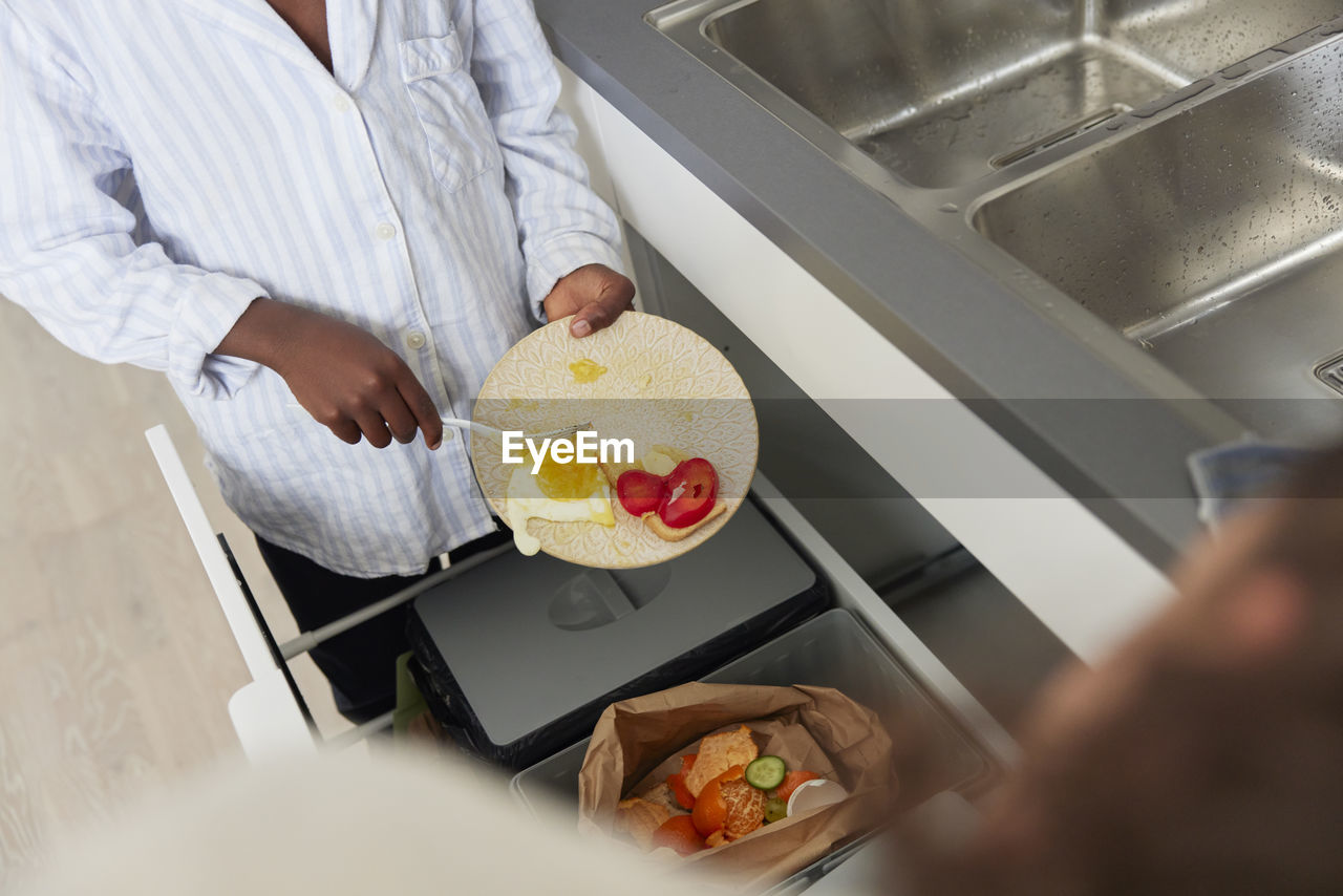 Boy throwing out leftover food