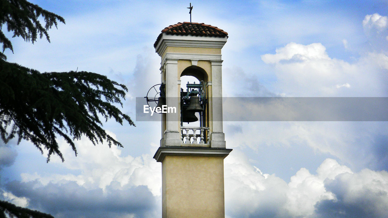 Low angle view of bell tower against cloudy sky