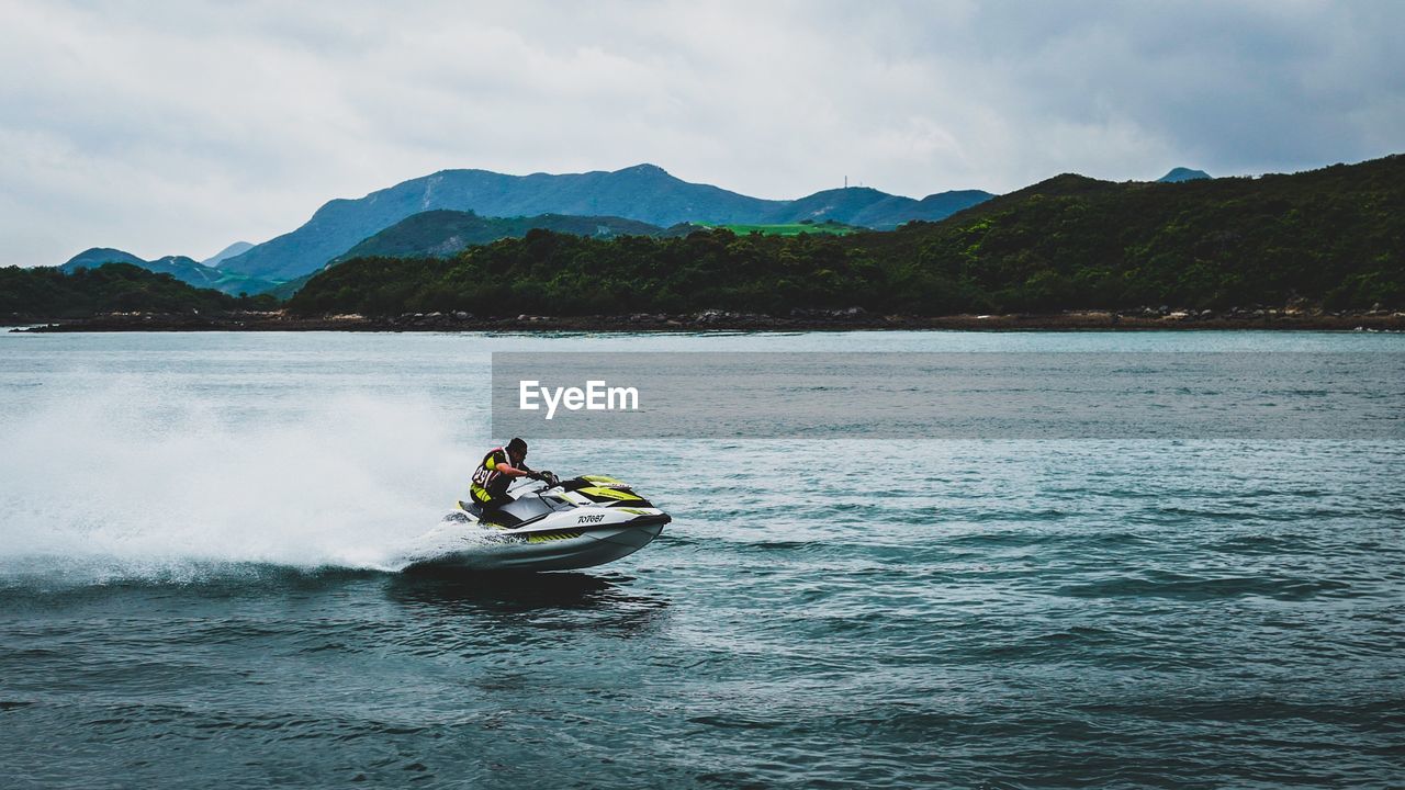 Man riding jet boat in sea