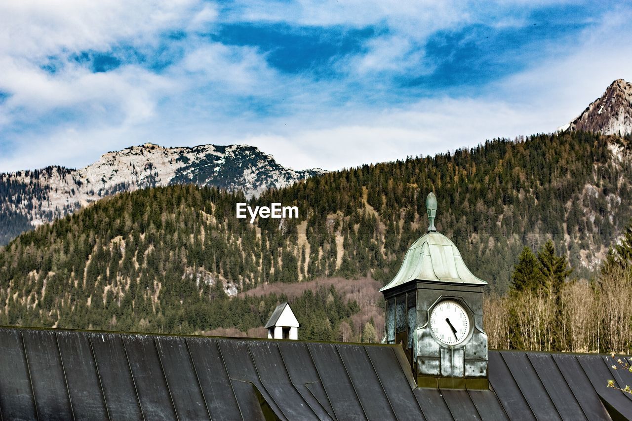 Built structure by trees against sky