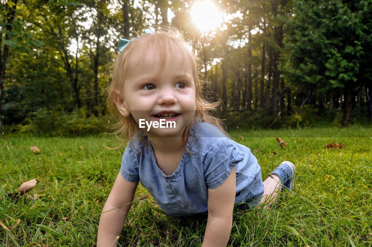 Baby girl on grassy land