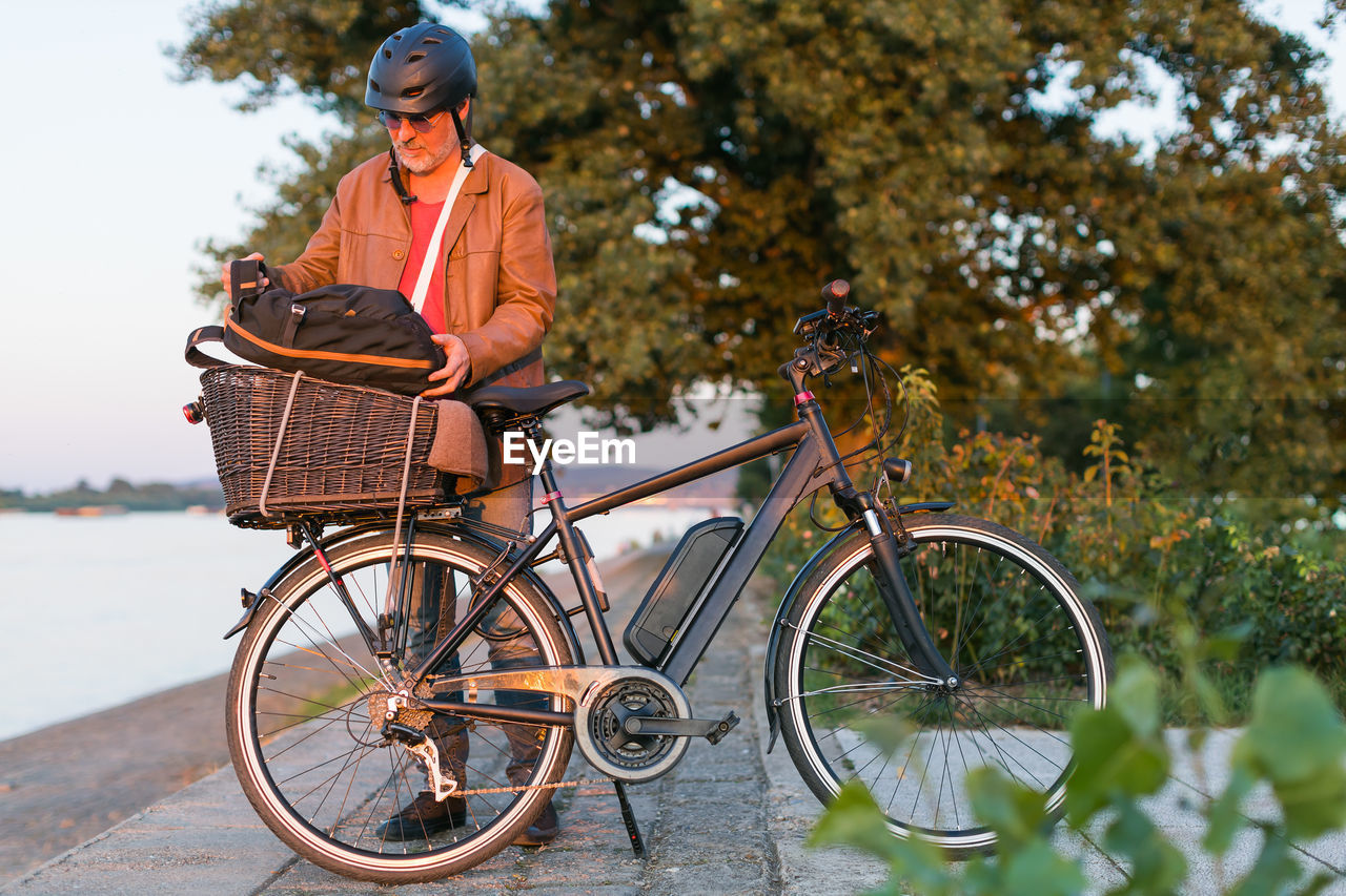 Man standing in front of electric bicycle