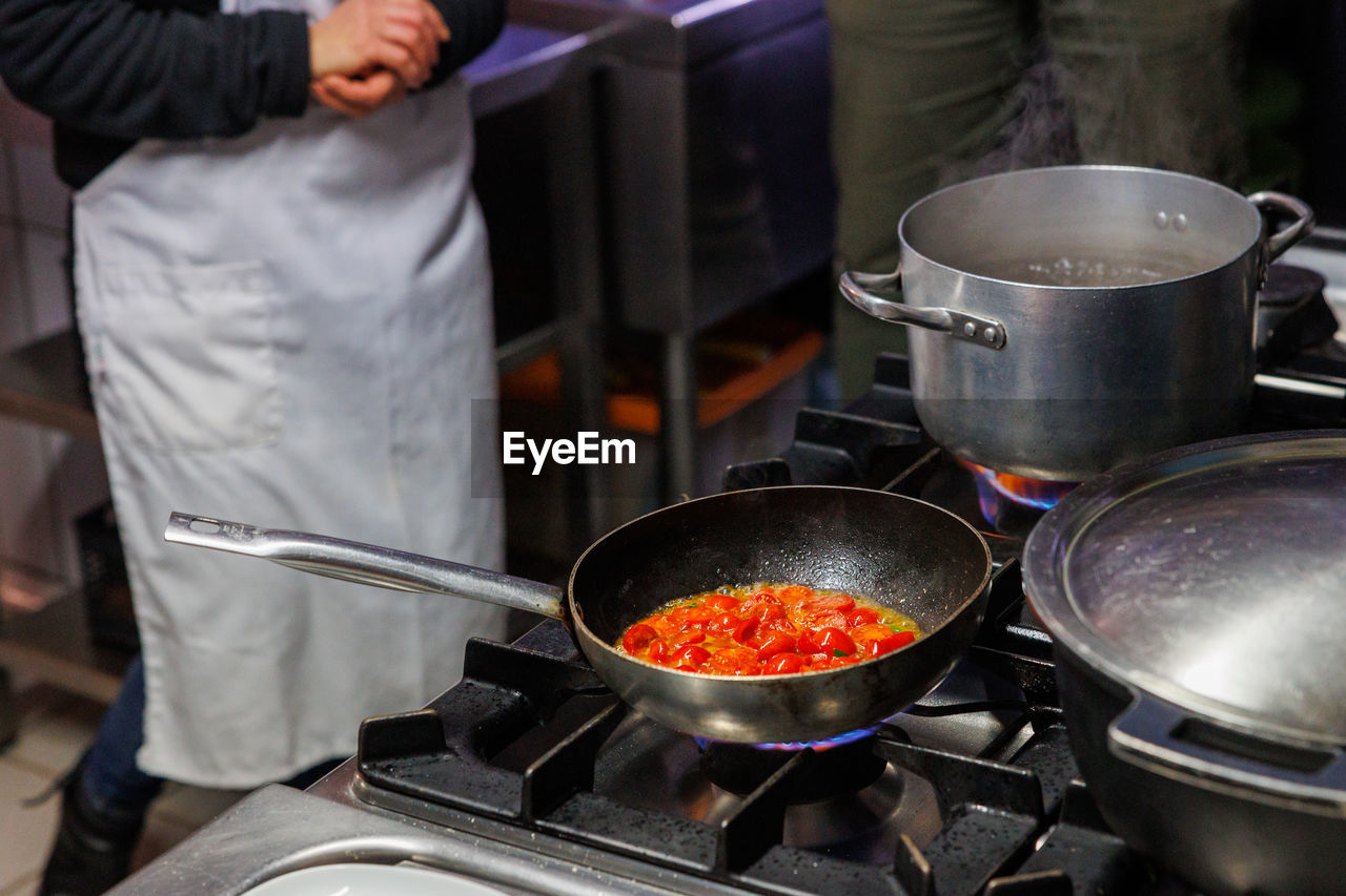 midsection of chef cooking pan