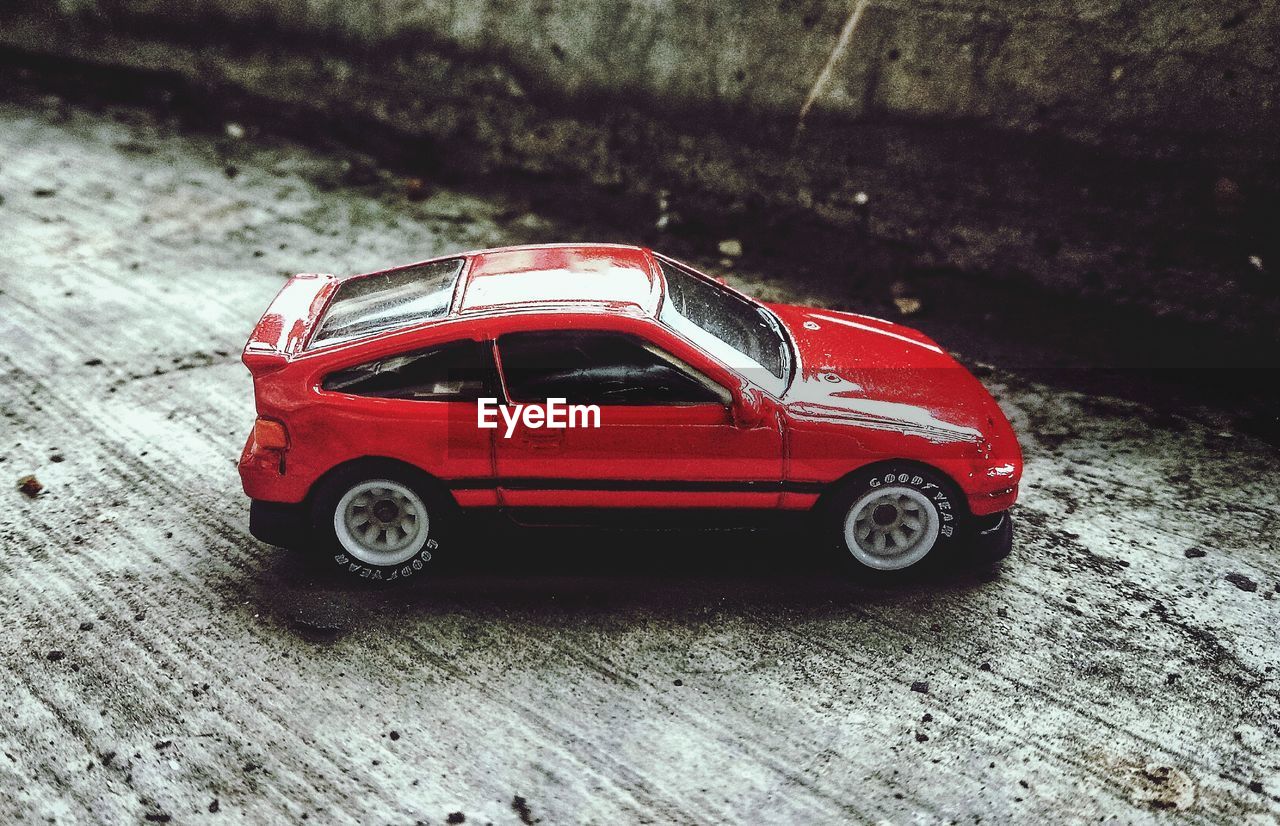 RED TOY CAR ON STREET