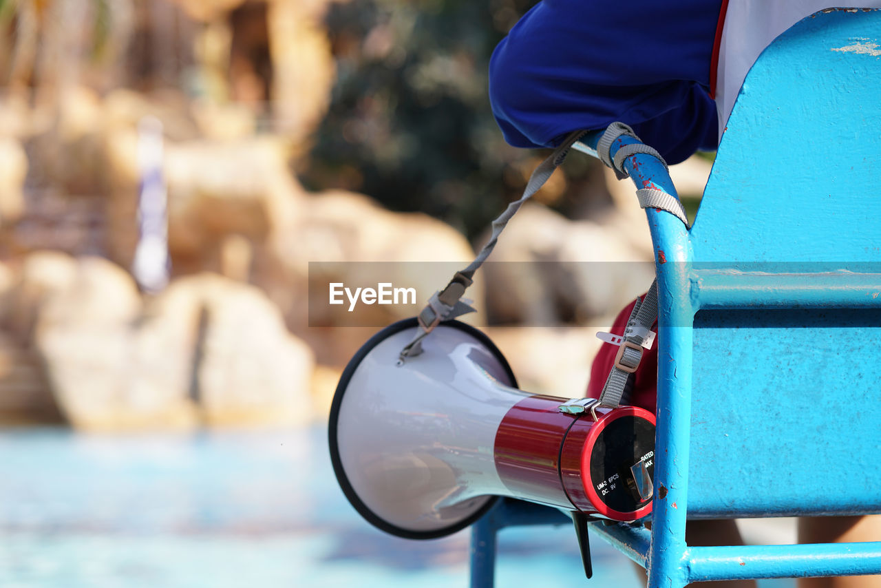 Close-up of person on chair with megaphone 