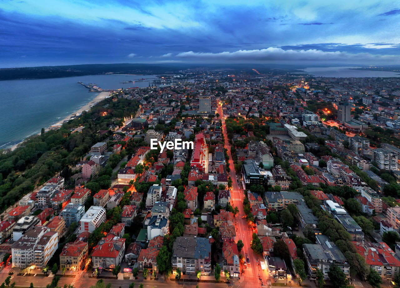 High angle view of townscape by sea against sky